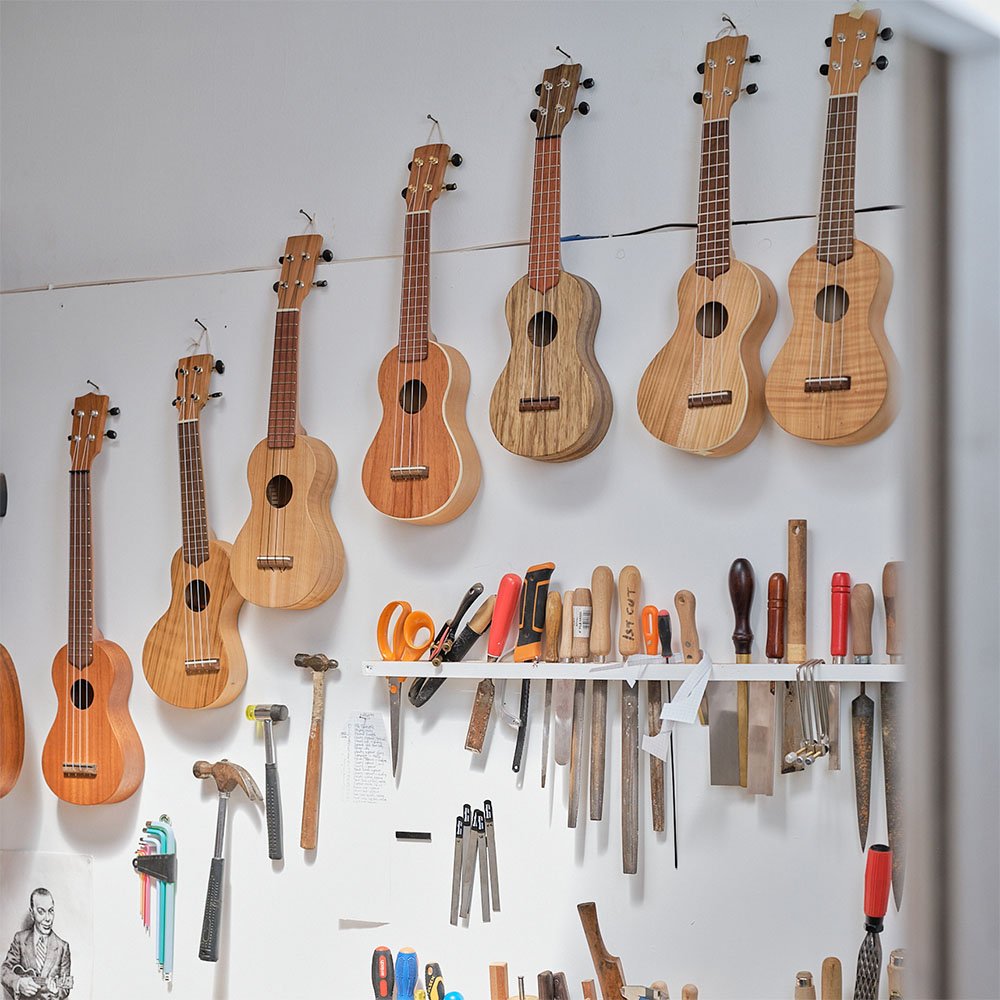 Ukuleles hanging on a wall in Will's workshop.